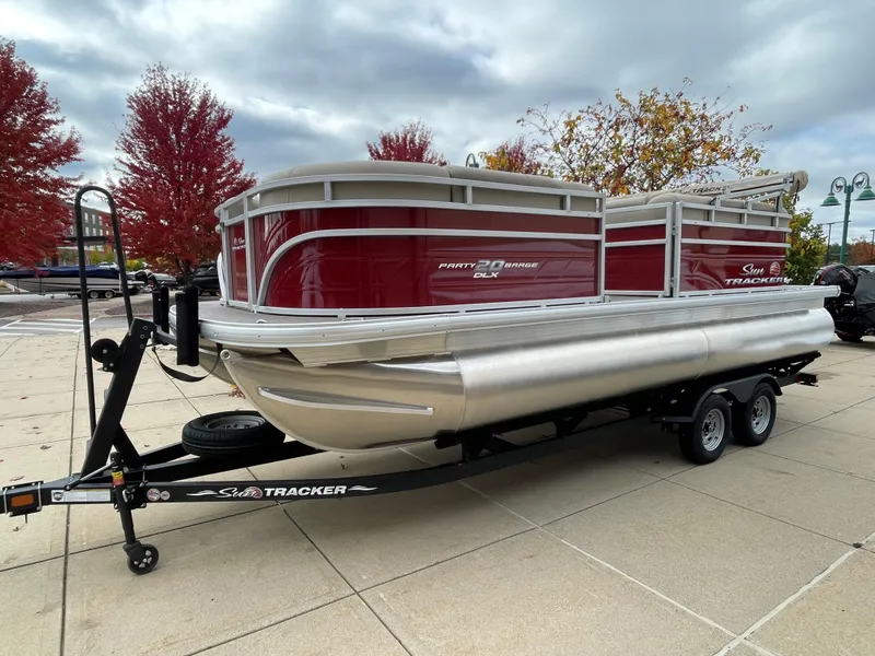 The Image of 2024 Sun Tracker Party Barge 20 DLX pontoon boat on a trailer. - 0
