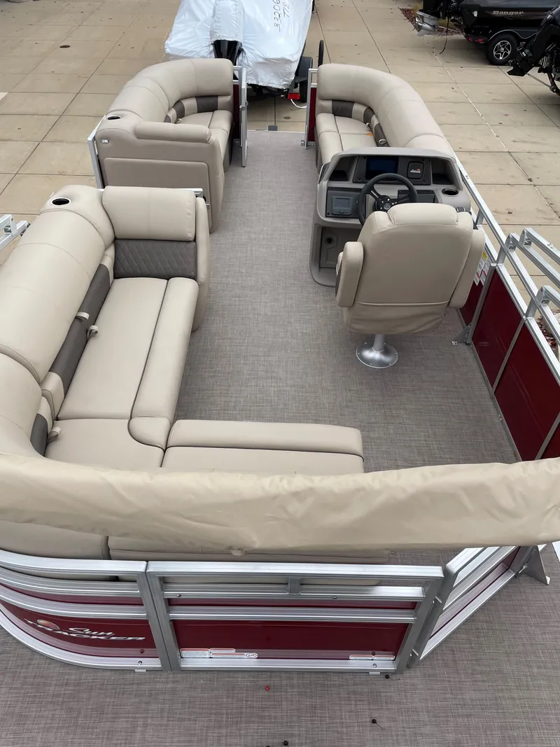 Slide: The Image of 2024 Sun Tracker Party Barge 20 DLX pontoon boat with beige seating and red exterior. - 2