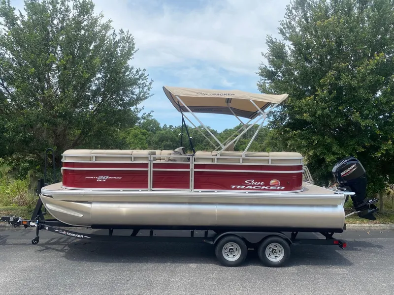 Slide: The Image of 2024 Sun Tracker Party Barge 20 DLX pontoon boat on trailer. - 3
