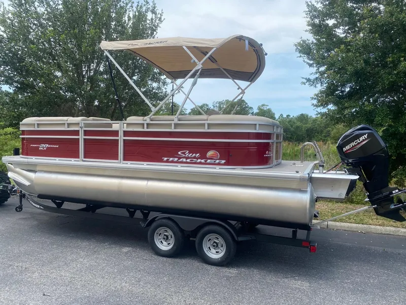 Slide: The Image of 2024 Sun Tracker Party Barge 20 DLX pontoon boat with canopy and Mercury outboard motor. - 4