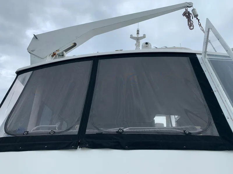 Slide: The Image of Alt text: 1998 Viking 60 CMY boat with covered windows and crane arm. - 10