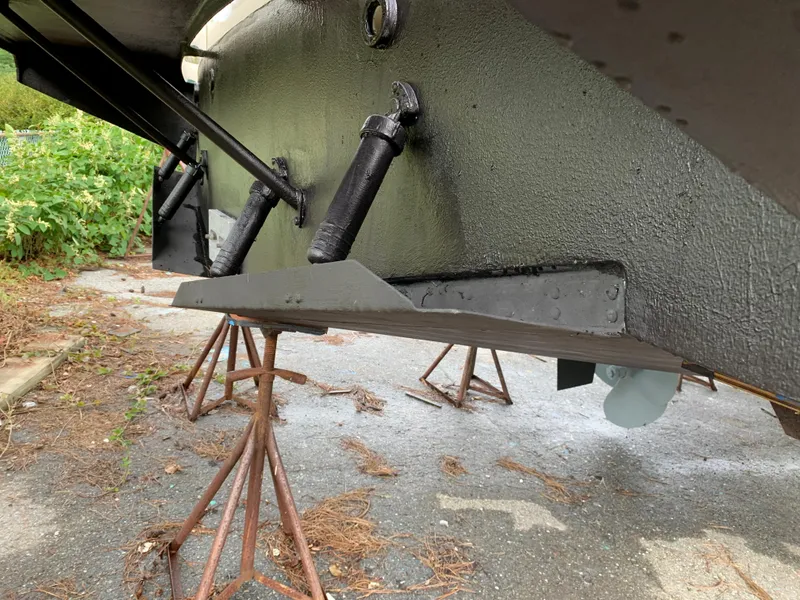 Slide: The Image of Close-up of the underside of a 1998 Viking 60 CMY boat on stands. - 18