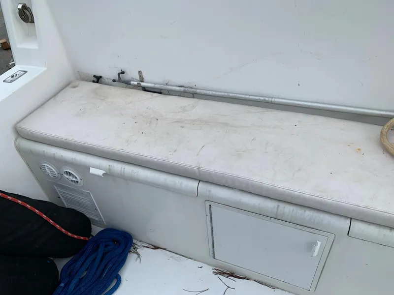 Slide: The Image of Worn seating area on a 1998 Viking 60 CMY boat with storage compartments. - 24