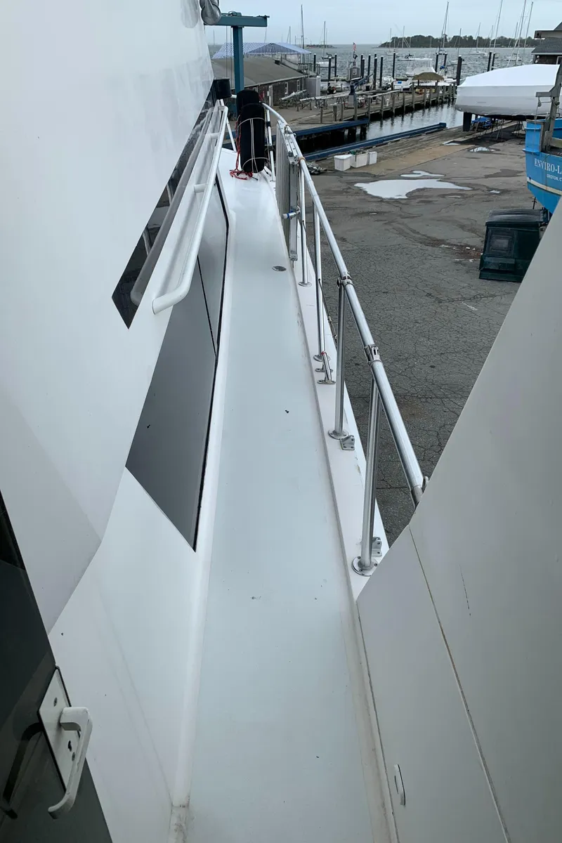Slide: The Image of Side deck of a 1998 Viking 60 CMY yacht at a marina. - 31