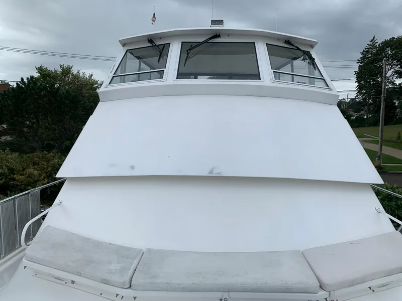 Slide: The Image of 1998 Viking 60 CMY yacht with white exterior and cushioned seating. - 33