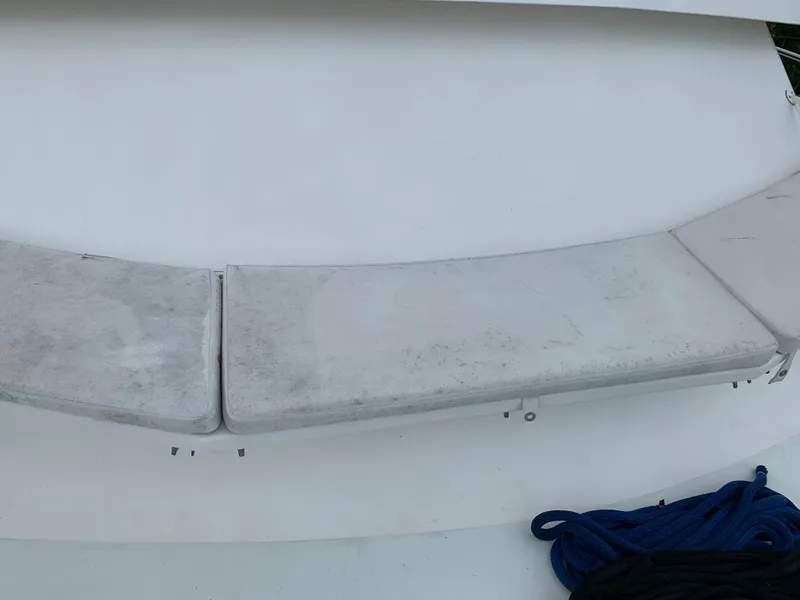 Slide: The Image of Worn seating area on a 1998 Viking 60 CMY yacht with blue rope. - 34