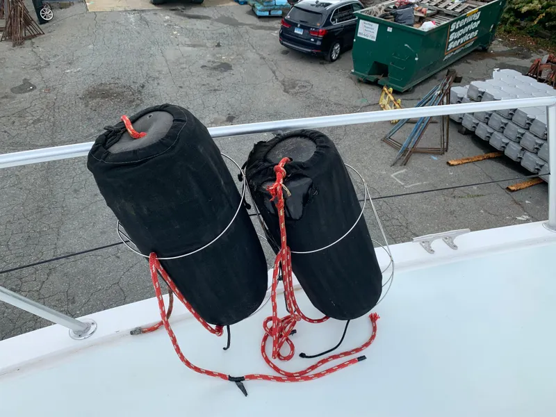 Slide: The Image of Two black fenders with red ropes on a 1998 Viking 60 CMY yacht. - 38
