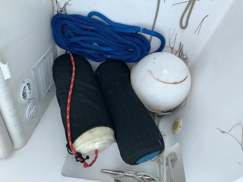 Slide: The Image of Boat storage compartment with ropes, fenders, and buoy on a 1998 Viking 60 CMY. - 39