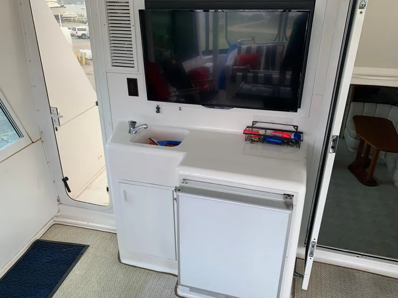 Slide: The Image of Interior of 1998 Viking 60 CMY yacht with TV, sink, and mini-fridge. - 45