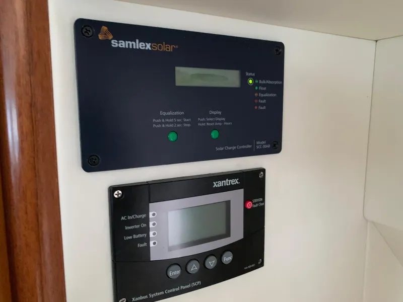 Slide: The Image of Samlex Solar and Xantrex control panels on a 1998 Viking 60 CMY yacht. - 49
