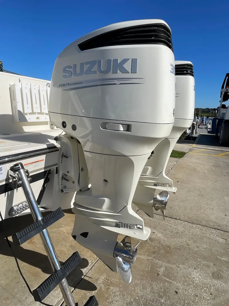 Slide: The Image of Twin Suzuki outboard motors on a 2005 Pursuit 3070 Offshore boat. - 18