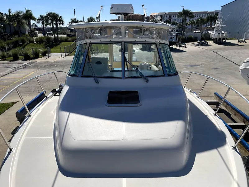 Slide: The Image of 2005 Pursuit 3070 Offshore boat docked at a marina. - 28