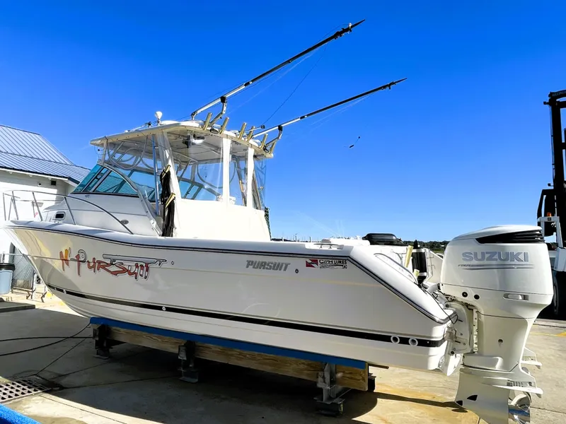 Slide: The Image of 2005 Pursuit 3070 Offshore boat with Suzuki outboard motor on a trailer. - 4