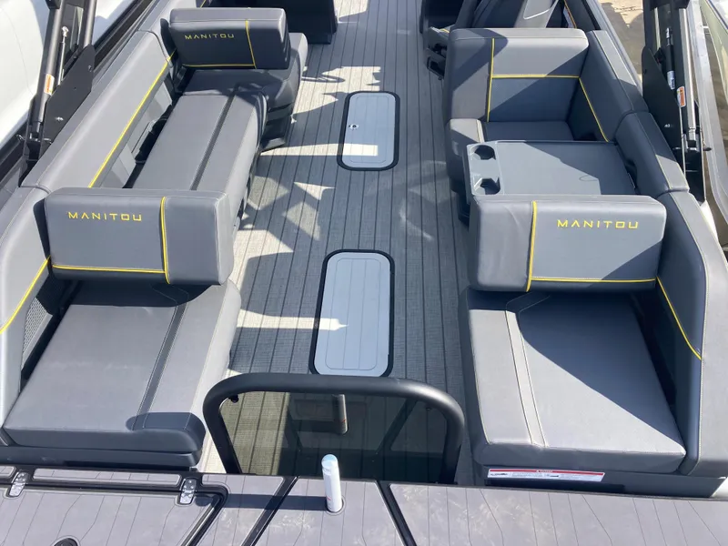 Slide: The Image of 2024 Manitou Explorer 24 Switchback 24 MAX Trifold Stealth interior with gray seating and yellow accents. - 18
