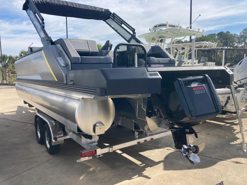 Slide: The Image of 2024 Manitou Explorer 24 Switchback 24 MAX Trifold Stealth pontoon boat on trailer. - 3