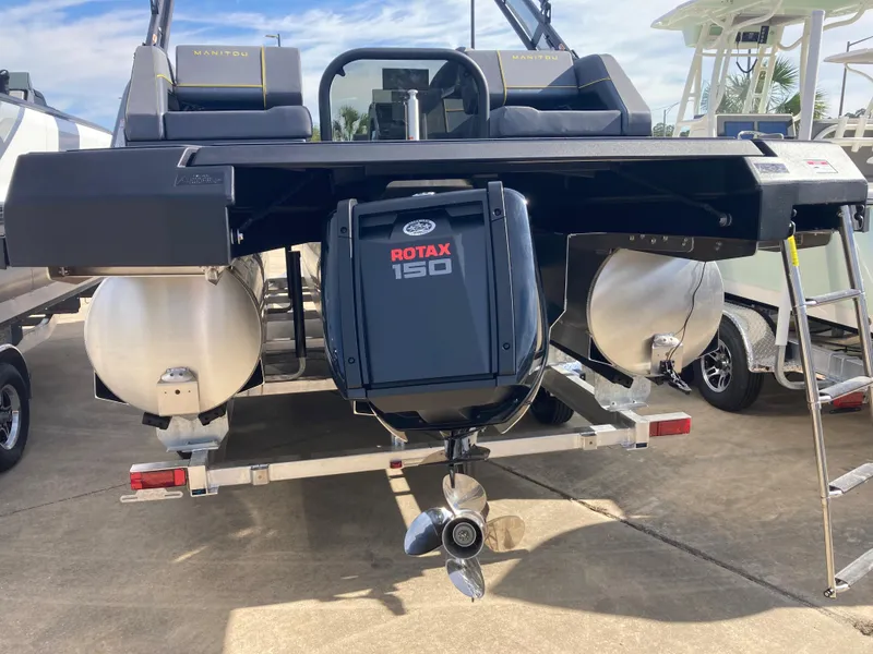 Slide: The Image of 2024 Manitou Explorer 24 Switchback 24 MAX Trifold Stealth with Rotax 150 engine, rear view. - 4