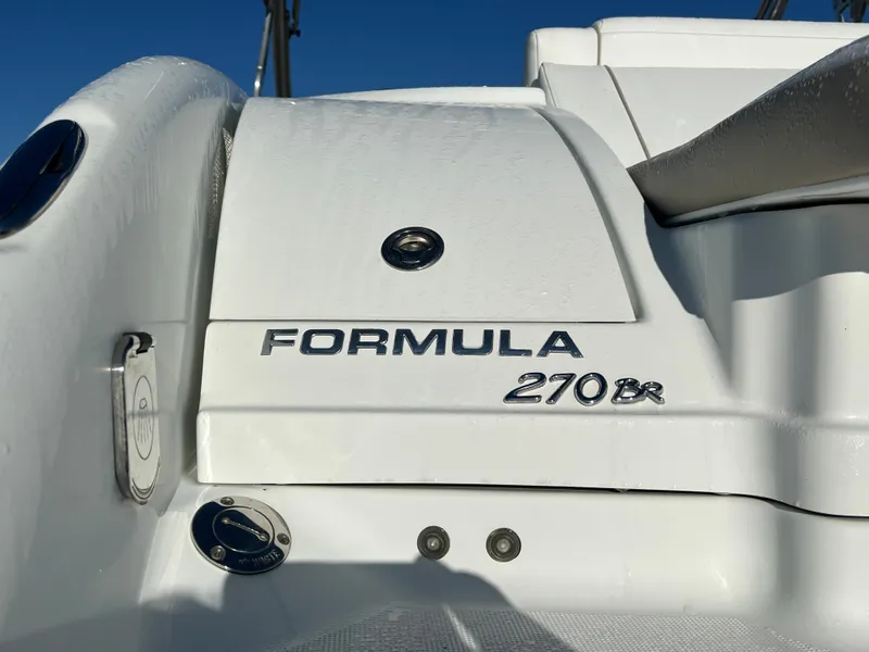Slide: The Image of 2013 Formula 270 Bowrider boat rear view with model name and logo. - 14