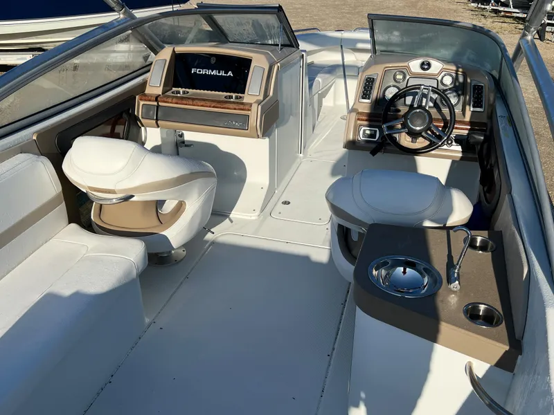 Slide: The Image of 2013 Formula 270 Bowrider boat interior with steering wheel and seating. - 19