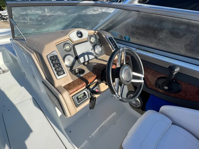 Slide: The Image of 2013 Formula 270 Bowrider boat dashboard with steering wheel and control panel. - 23