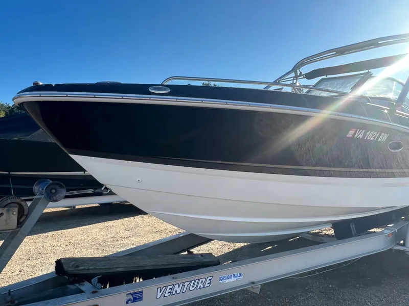 Slide: The Image of 2013 Formula 270 Bowrider boat on a Venture trailer under clear blue sky. - 3