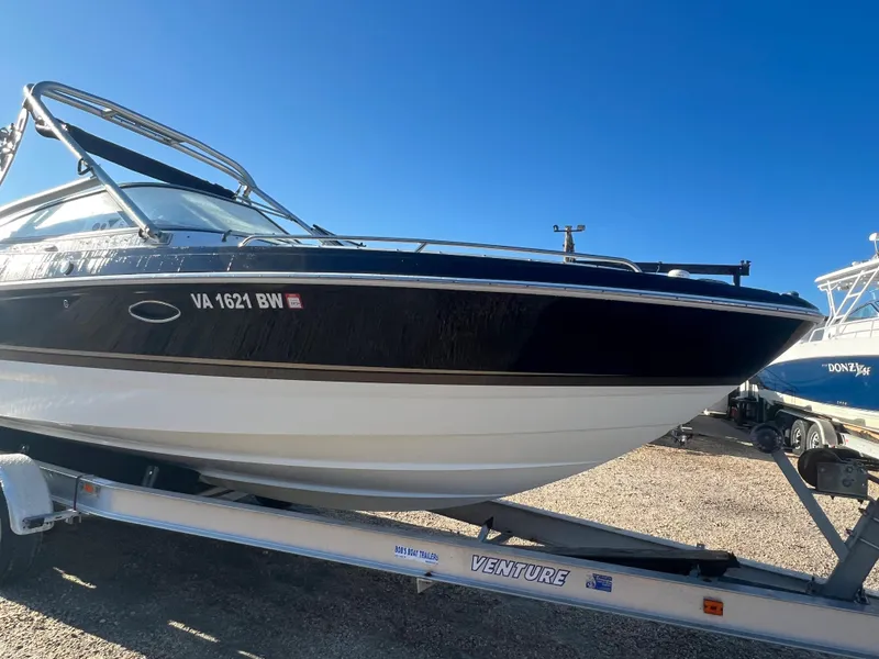 Slide: The Image of 2013 Formula 270 Bowrider boat on Venture trailer under clear blue sky. - 4