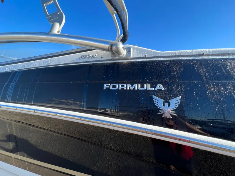 Slide: The Image of 2013 Formula 270 Bowrider boat side view with logo and blue sky background. - 45