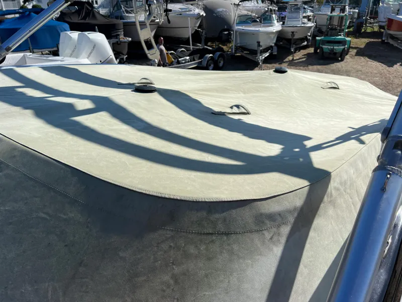 Slide: The Image of 2013 Formula 270 Bowrider boat with cover in a marina. - 48