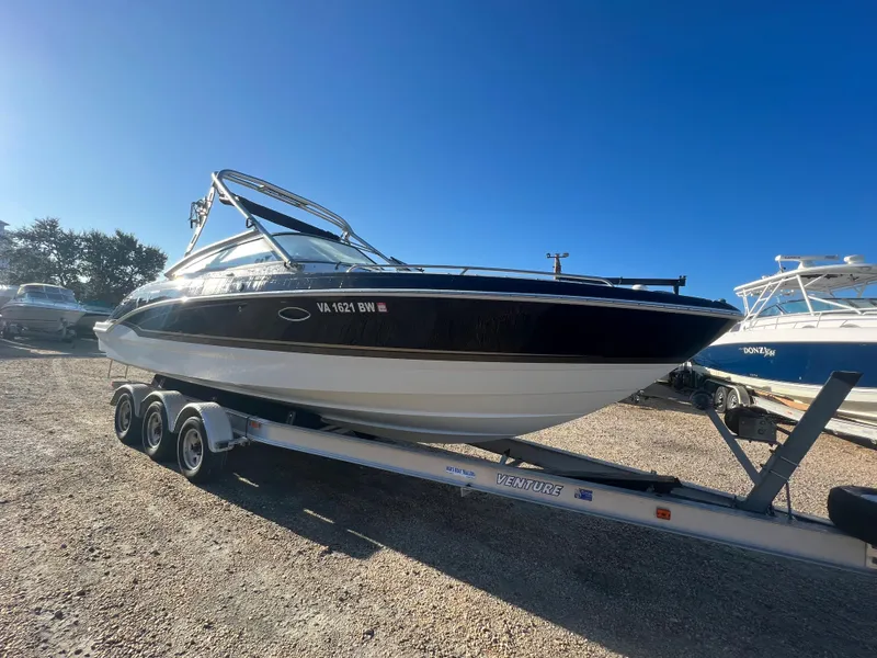 Slide: The Image of 2013 Formula 270 Bowrider boat on a trailer under clear blue sky. - 5