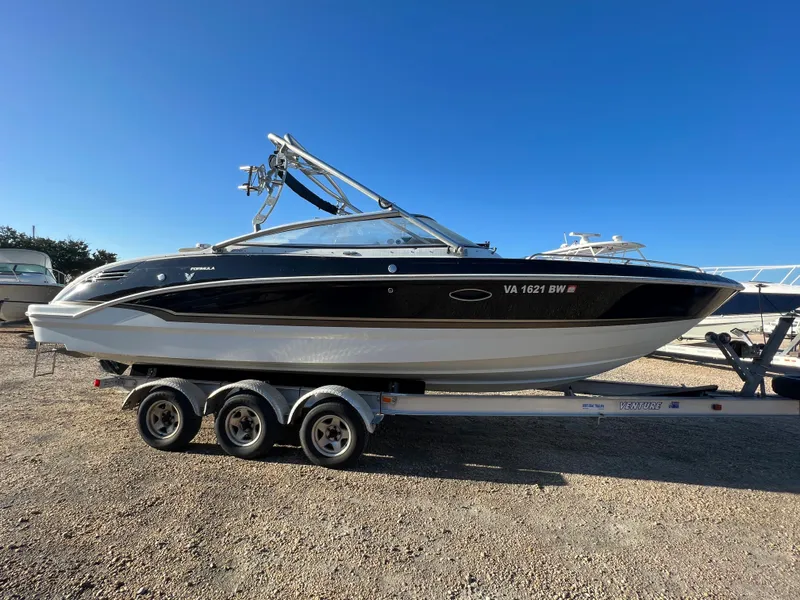 Slide: The Image of 2013 Formula 270 Bowrider boat on a triple-axle trailer in a sunny outdoor setting. - 6