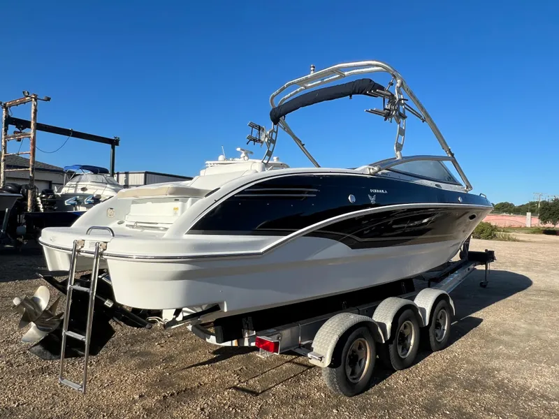 Slide: The Image of 2013 Formula 270 Bowrider boat on a triple-axle trailer in a sunny outdoor setting. - 9