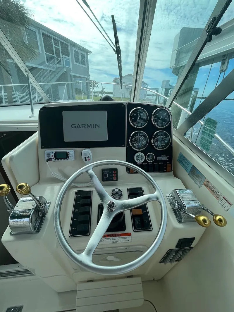 Slide: The Image of Helm of 2000 Pursuit 3000 Express boat with Garmin navigation system. - 10