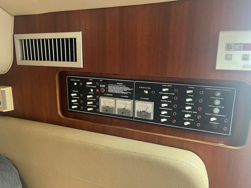 Slide: The Image of Control panel of a 2000 Pursuit 3000 Express boat with wooden interior. - 17