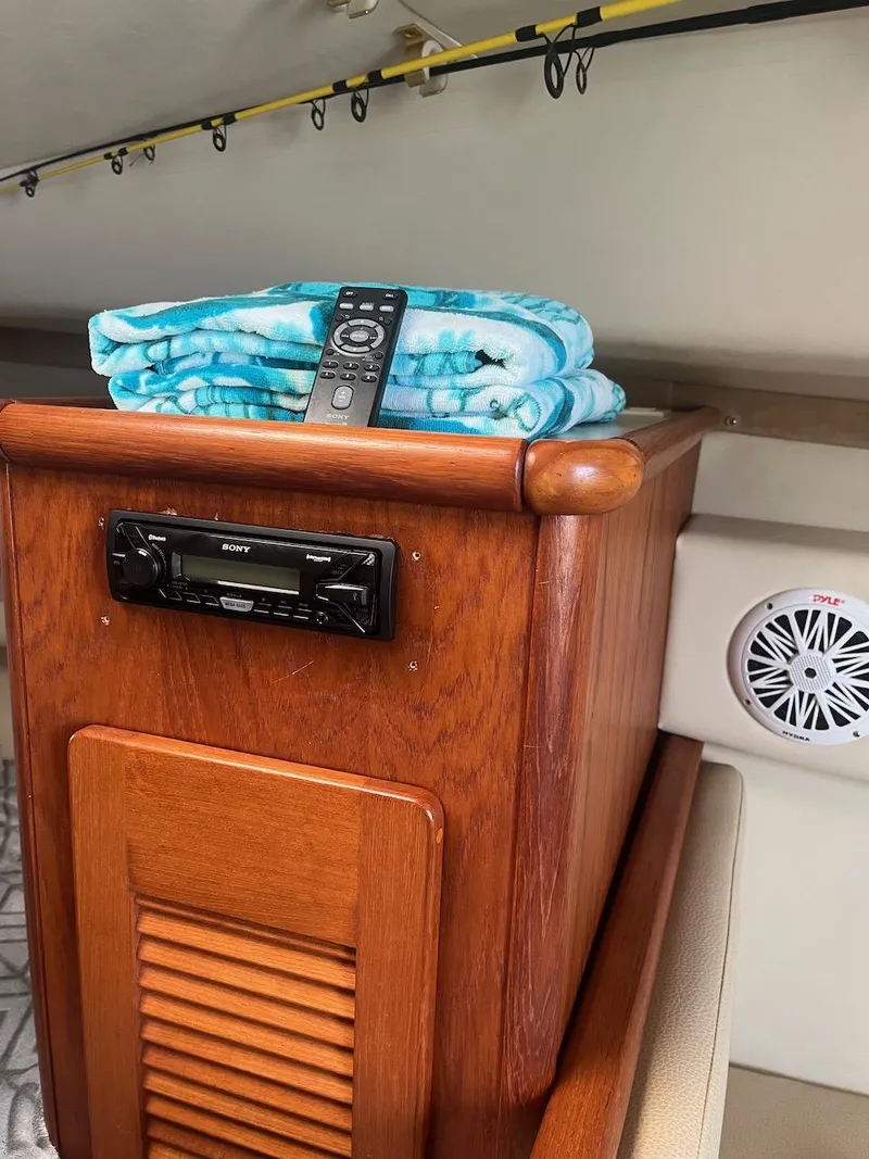 Slide: The Image of Interior of a 2000 Pursuit 3000 Express boat with wooden cabinetry and audio system. - 20