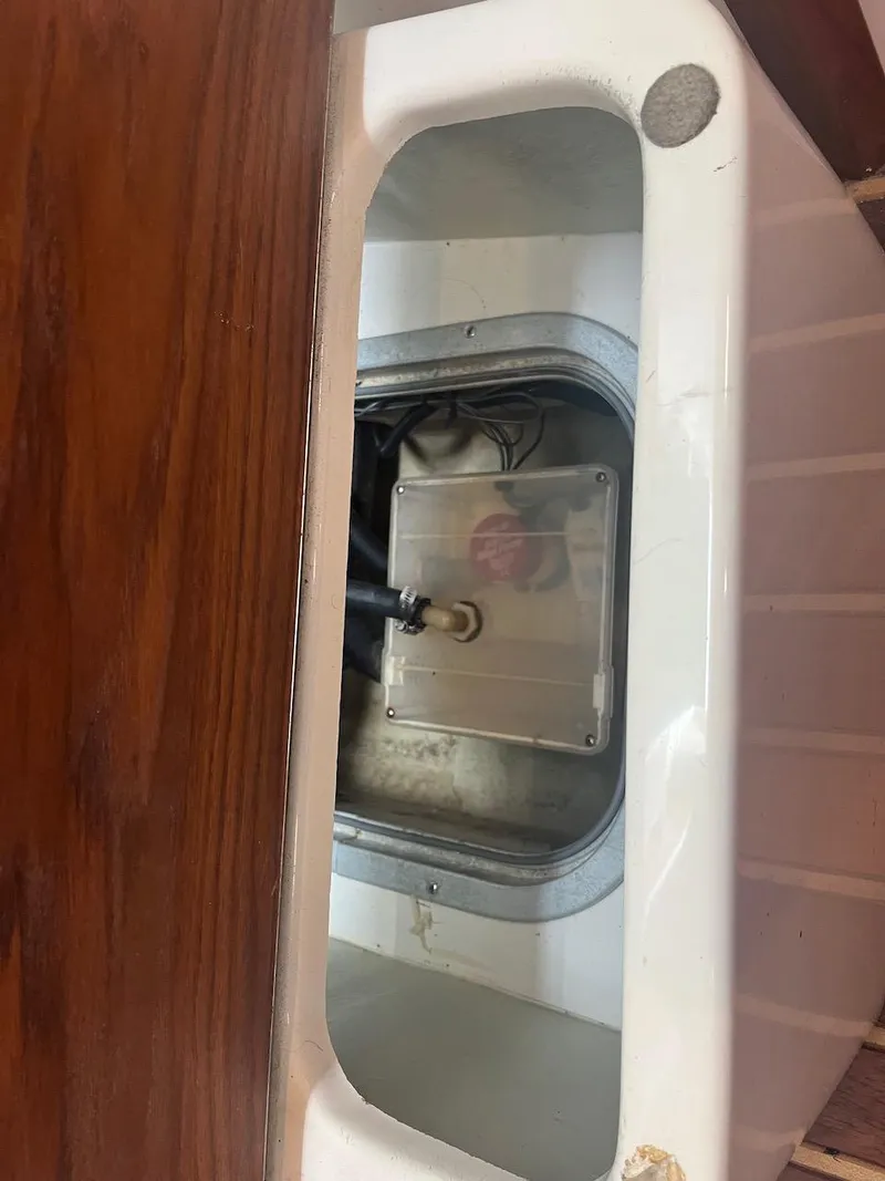 Slide: The Image of 2000 Pursuit 3000 Express boat interior compartment with visible wiring and components. - 21