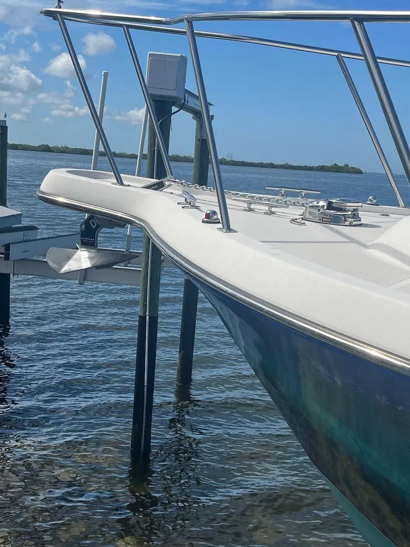 Slide: The Image of 2000 Pursuit 3000 Express boat docked by the water. - 25