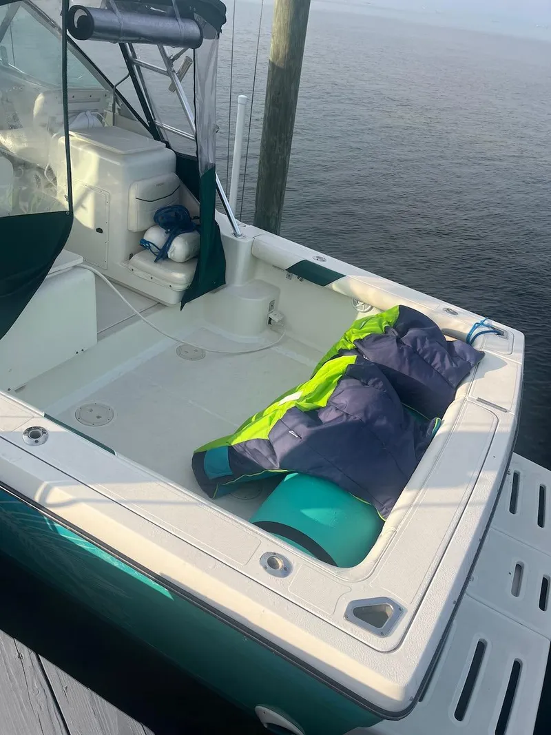 Slide: The Image of 2000 Pursuit 3000 Express boat docked with life jackets on deck. - 3