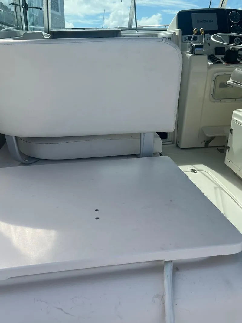 Slide: The Image of 2000 Pursuit 3000 Express boat interior with white seating and control panel. - 8