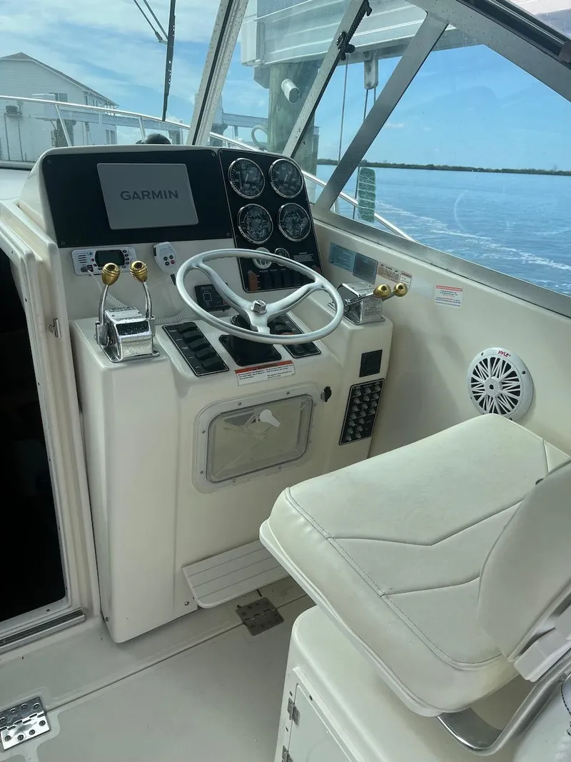 Slide: The Image of 2000 Pursuit 3000 Express boat helm with Garmin navigation system. - 9