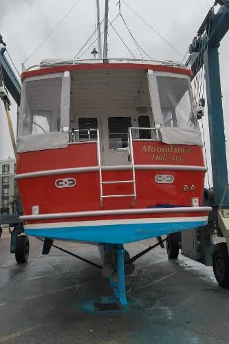 Slide: The Image of Red 2007 Custom Rockport Steel Trawler MY Moondance on a boat lift. - 10
