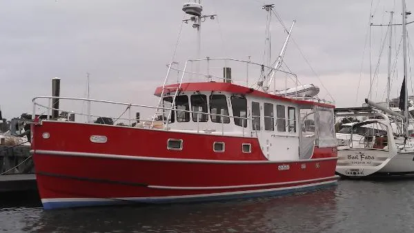 Slide: The Image of Red 2007 Custom Rockport Steel Trawler MY docked at marina. - 2
