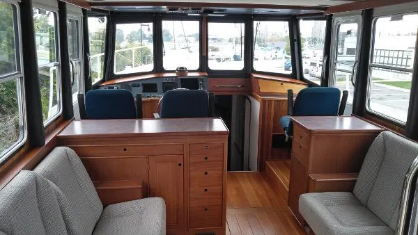Slide: The Image of Interior of 2007 Custom Rockport Steel Trawler MY with wooden cabinetry and seating. - 21