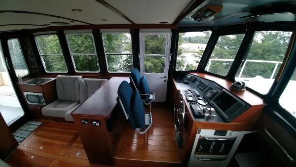 Slide: The Image of Interior of 2007 Custom Rockport Steel Trawler MY with helm, seating, and navigation equipment. - 23