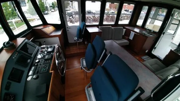 Slide: The Image of Interior of 2007 Custom Rockport Steel Trawler MY with helm, seating, and large windows. - 32