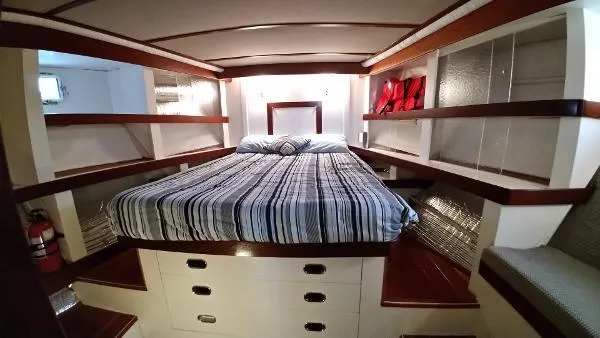 Slide: The Image of Luxurious bedroom in 2007 Custom Rockport Steel Trawler MY with striped bedding and ample storage. - 44