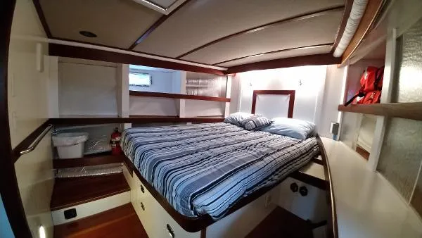 Slide: The Image of Cozy bedroom in 2007 Custom Rockport Steel Trawler MY with striped bedding. - 45