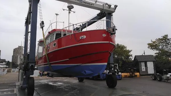 Slide: The Image of Red 2007 Custom Rockport Steel Trawler MY on a boat lift for maintenance. - 5