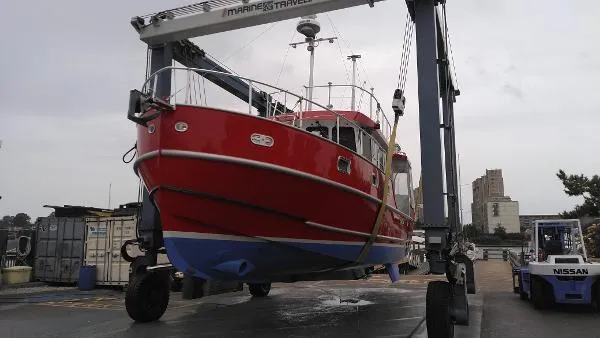 Slide: The Image of Red 2007 Custom Rockport Steel Trawler MY on a marine travel lift. - 6