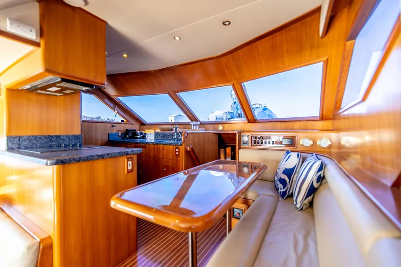 Slide: The Image of Luxurious interior of 2003 Ocean Alexander 48 Sedan yacht with wooden finishes and plush seating. - 12