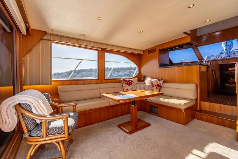 Slide: The Image of Luxurious interior of a 2003 Ocean Alexander 48 Sedan yacht with plush seating and wooden accents. - 13