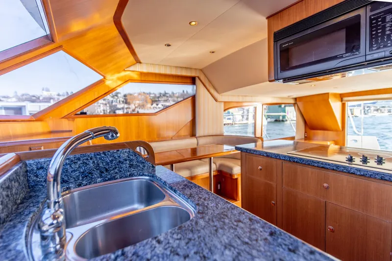 Slide: The Image of Luxurious kitchen interior of 2003 Ocean Alexander 48 Sedan yacht with granite countertops and modern appliances. - 15